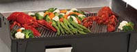 Vegetables being steamed on a grill.