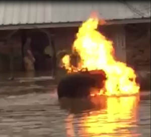 Burning Propane Tank floating in flood